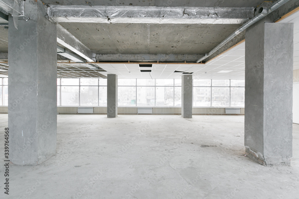 empty pure commercial office building undecorated in gray colors.open space office empty pure commercial office building undecorated in gray colors.open space office