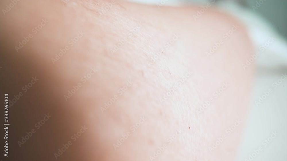 Macro: modern technology to do laser epilation procedure on client bare leg with hair removal machine in cosmetic salon closeup Macro: modern technology to do laser epilation procedure on client bare leg with hair removal machine in cosmetic salon closeup