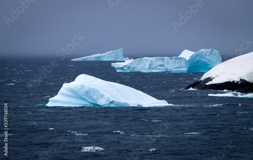 Icebergs floating in the Antarctic after calving off the numerous glaciers in the area.