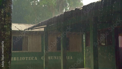 Rain pouring off Metal Corrugated roof of Rural building. photo
