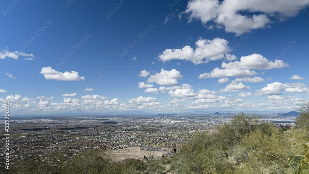 Phoenix, Arizona - March 14 2020: Looking across Phoenix from Dobbins Lookout in a wide timelapse as clouds flow overhead. Phoenix, Arizona - March 14 2020: Looking across Phoenix from Dobbins Lookout in a wide timelapse as clouds flow overhead.