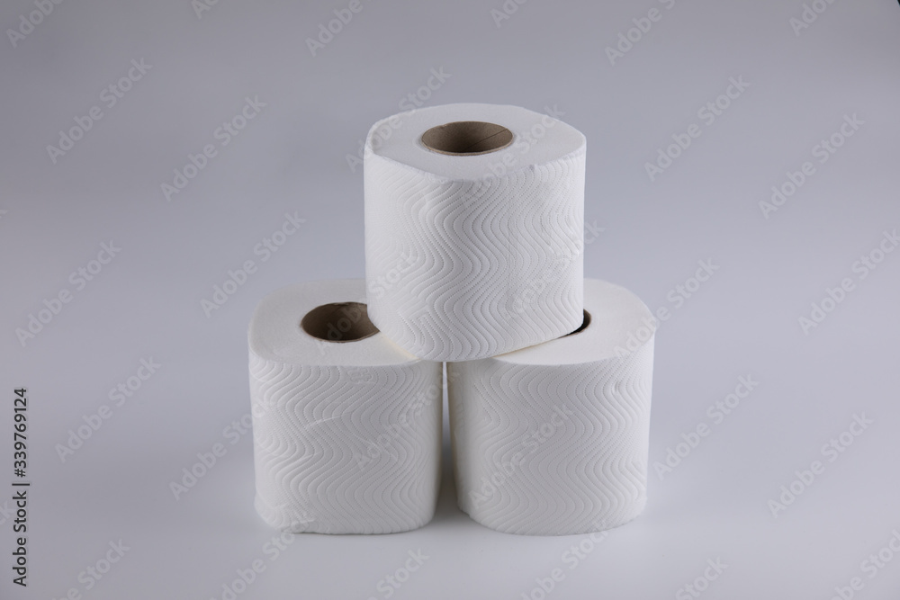 The three unused toilet paper rolls were placed vertically like a pyramid, shot on white background reminiscent of the concept of being together with supporting from others, such as family or friends The three unused toilet paper rolls were placed vertically like a pyramid, shot on white background reminiscent of the concept of being together with supporting from others, such as family or friends