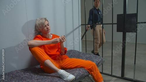 Woman criminal misses a prison cell. Medium Full Shot