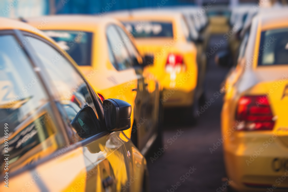 Fototapeta premium View of yellow taxi cab parking lot with yellow cars standing, set of taxicabs in the streets, taxis