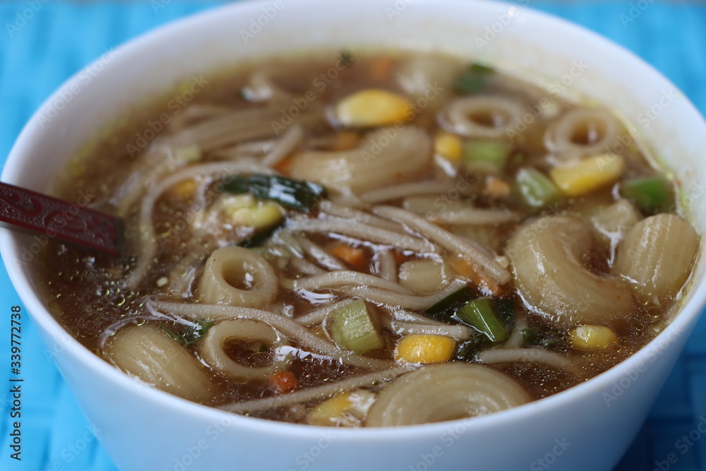 Vegetable Thukpa in white bowl. Thukpa is Tibetan cuisine noodle soup with vegetables Vegetable Thukpa in white bowl. Thukpa is Tibetan cuisine noodle soup with vegetables