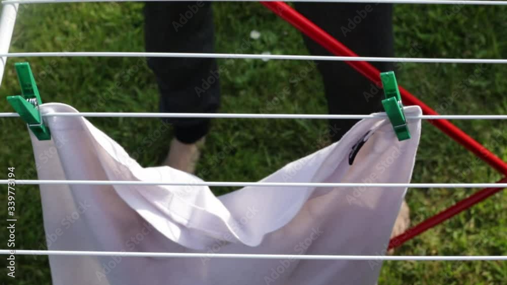 Woman hanging clothes on a line outside