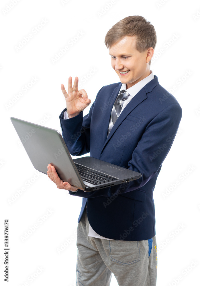 A young businessman leads an online meeting at a computer in home shorts. Stay at home while quarantined while the world is in pandemic or epidemic of the virus. Isolated on a white background. A young businessman leads an online meeting at a computer in home shorts. Stay at home while quarantined while the world is in pandemic or epidemic of the virus. Isolated on a white background.