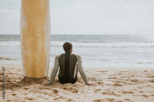 Photography Surfer resting on the beach
