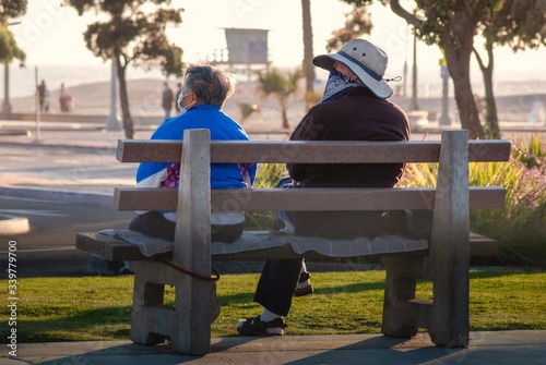 Couple sitting on a bench at the beach 