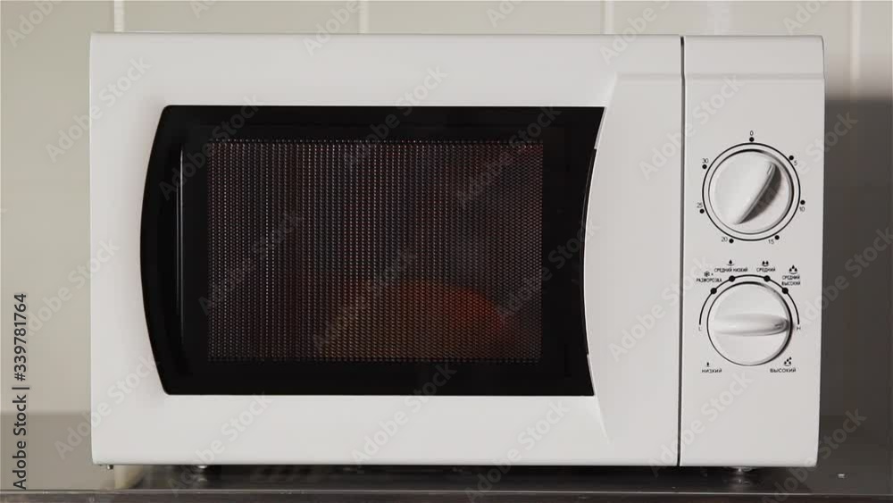 Close up of Microwave Oven works on table Close up of Microwave Oven works on table