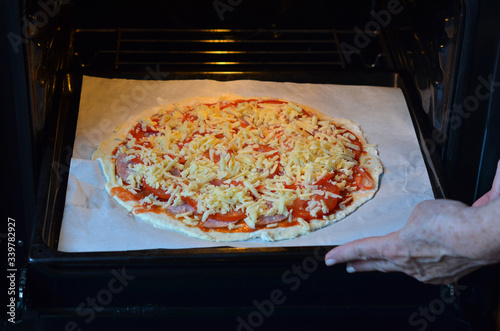 The pizza in the oven. Home cooking