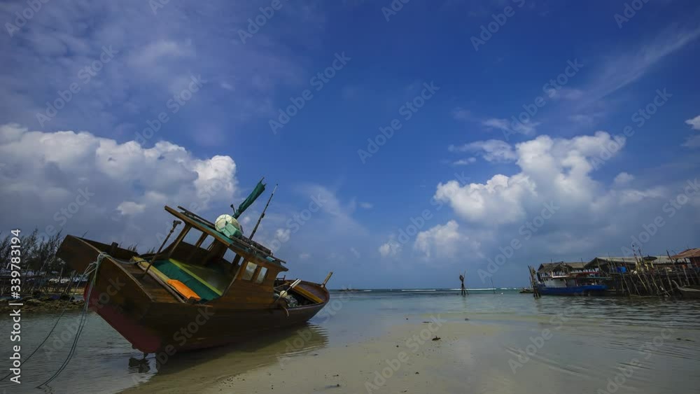 Cloud time lapse during low tide time with old fishing boat as a fore grounds. Cloud time lapse during low tide time with old fishing boat as a fore grounds.
