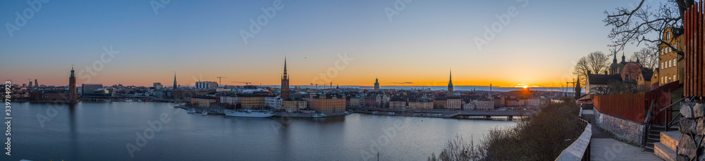 Morning view at sunrise over the districts of old town Gamla stan  and the Djurgården with orange skyline with silhouettes a sunny morning in Stockholm from the district of Södermalm.