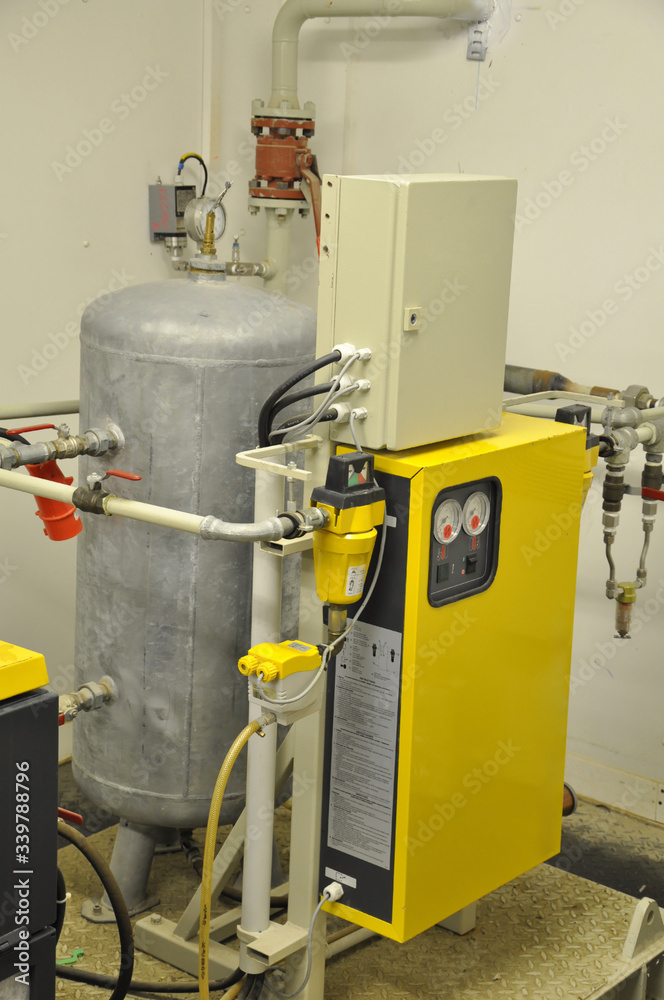 The industrial air compressor in the workshop The industrial air compressor in the workshop