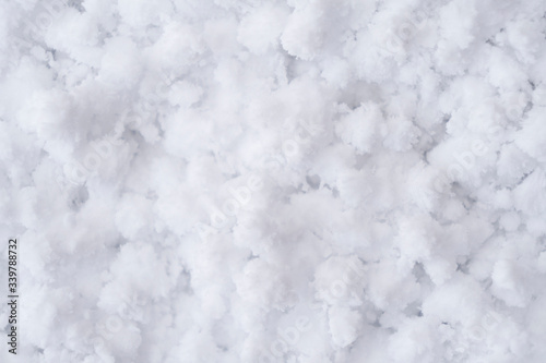 Background of fresh white snow. Winter snowflakes texture. Snow white texture winter background. Icy surface pattern. Shiny snow with bokeh. Macro shot