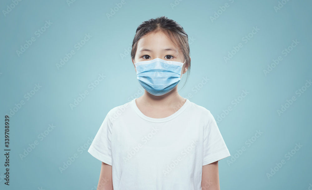Asian little girl wearing a protective hygiene protective mask Asian little girl wearing a protective hygiene protective mask