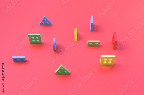 wooden colorful geometric shapes on pink background