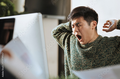 Sleepy office worker at his workstation