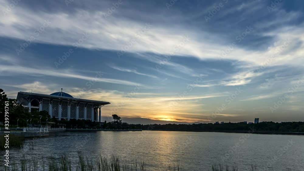 Sunset to twilight dramatic time lapse of the beautiful sky over the lake of the Sultan Mizan Mosque aka Masjid Besi in Putrajaya Malaysia. Sunset to twilight dramatic time lapse of the beautiful sky over the lake of the Sultan Mizan Mosque aka Masjid Besi in Putrajaya Malaysia.