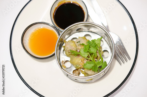 Chinese Steamed Dumpling on white dish served with Chili sauce and Soy sauce Dimsum pork