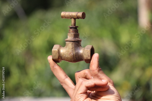 old water tap which is made of bronze held in hand 