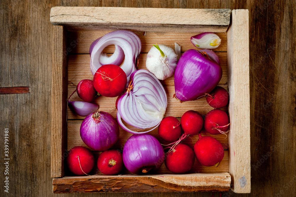 Red onion, radish and head of garlic. Background for cooking. Vegetables. Healthy nutrition, vitamins and vegetarianism. Red onion, radish and head of garlic. Background for cooking. Vegetables. Healthy nutrition, vitamins and vegetarianism.