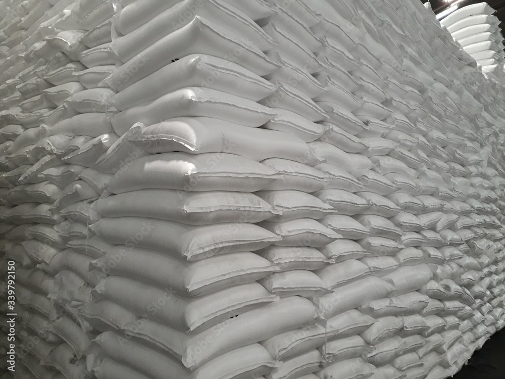 Obraz premium The product stock is packed in sacks, stacked in the warehouse, waiting for delivery.