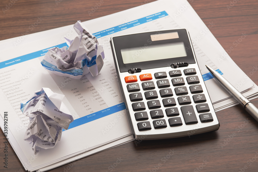 Calculator with accounting sheets and crumpled paper Calculator with accounting sheets and crumpled paper
