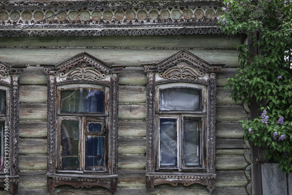 old russian traditional house with windows with plat bands