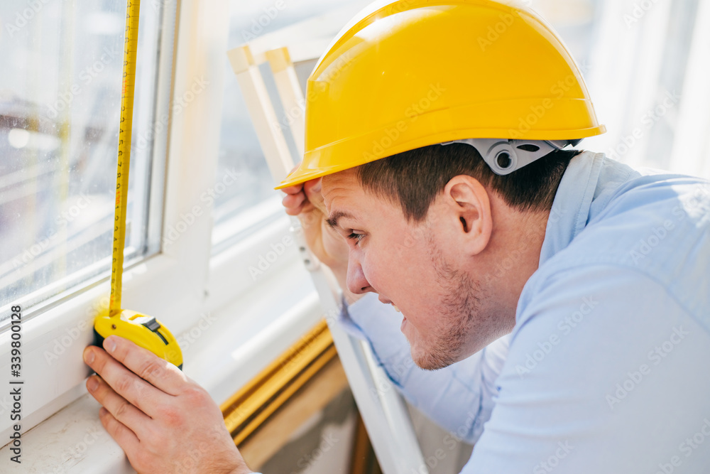 young engineer in a helmet metr the window young engineer in a helmet metr the window