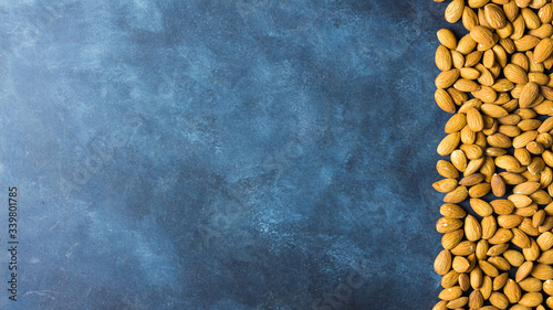 Almonds on a nice blue rustic background. Top view. Copy space. Healthy food concept 