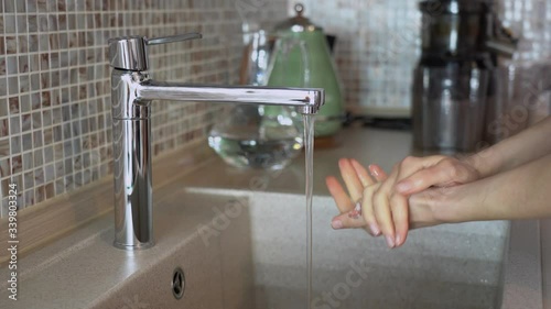 Young woman take white food salt rub in water using alternative to washing hands with sanitizer gel. Girl show proper handwashing technique close up. Stay isolation home self quarantine prevention.