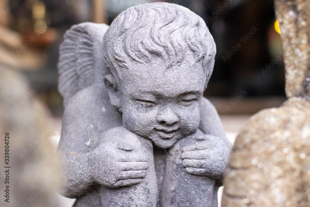 Stone statue of a little boy.