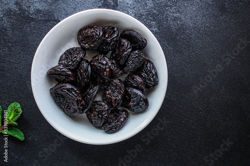 Quadro su tela prunes, dried plums (tasty and healthy fruits) desiccated keto or paleo diet
menu concept