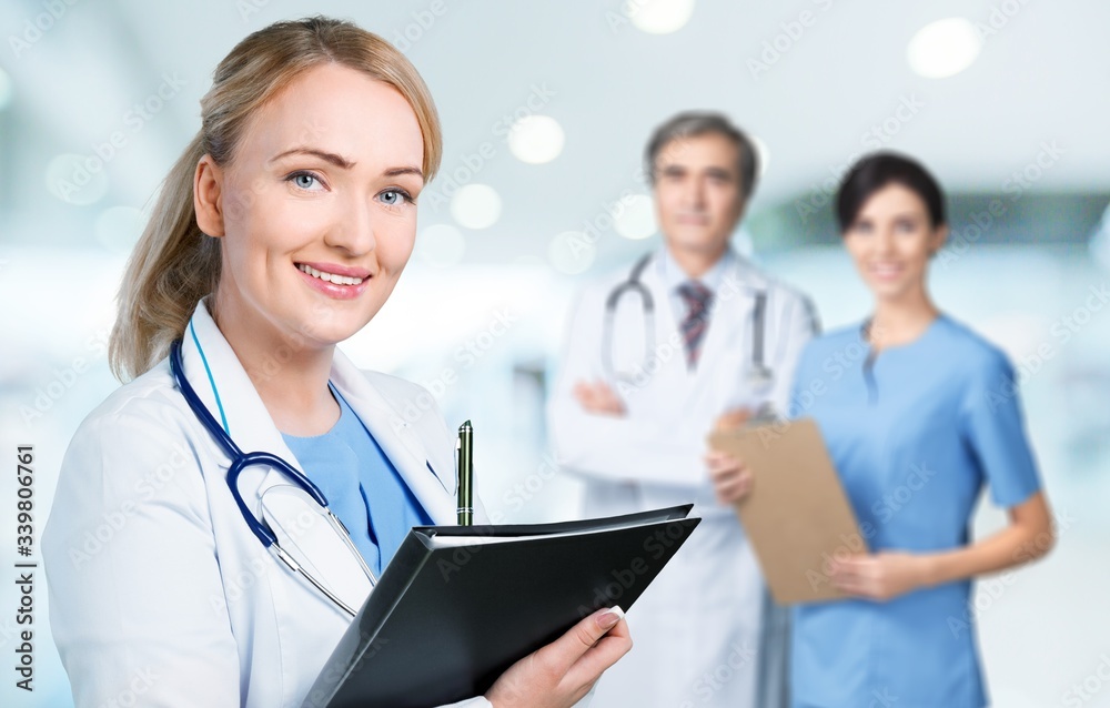 Young woman doctor on medical team background Young woman doctor on medical team background