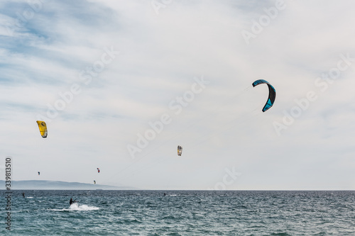 Man is practicing kitesurf on the sea