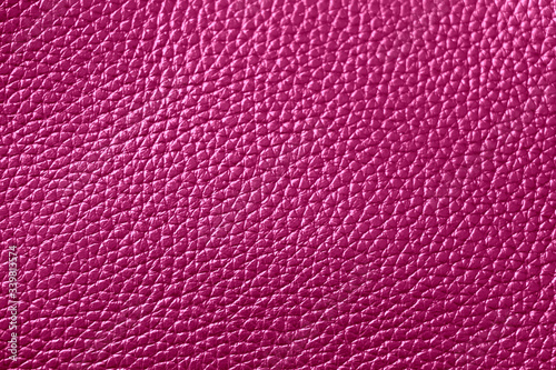 The texture of genuine leather. Natural skin texture close up. Purple background. 