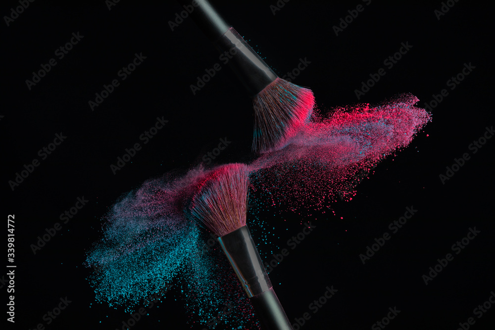 Two brushes with pink and blue make up powder impact to make cloud Two brushes with pink and blue make up powder impact to make cloud