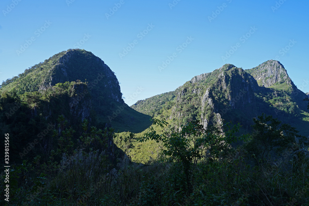 Natural landscape of green rocky mountain range with clear blue sky