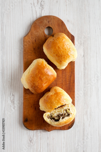 Home-baked Beef Russian Bierocks on a rustic wooden board, top view. Flat lay, overhead, from above. photo