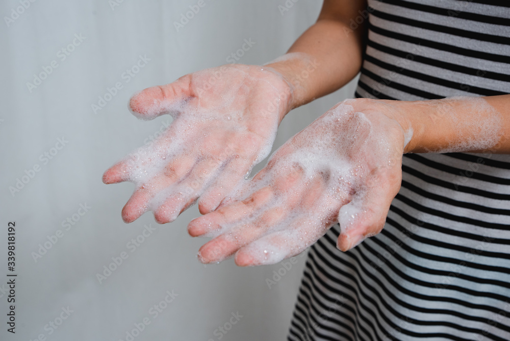 Fototapeta premium Mom shows daughter proper way to wash hands.