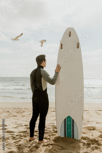 Professional surfer on the beach photo