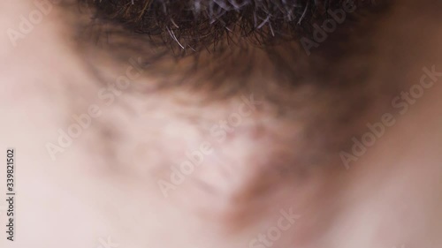 Macro footage of neck of young bearded man, selective focus photo