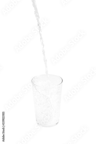 pouring water in glass isolated on white background