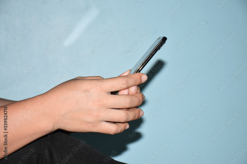 The hands connecting to the internet via phone to learning, shopping, connecting and working from home by technology, for work from home and business concept. The hands connecting to the internet via phone to learning, shopping, connecting and working from home by technology, for work from home and business concept.