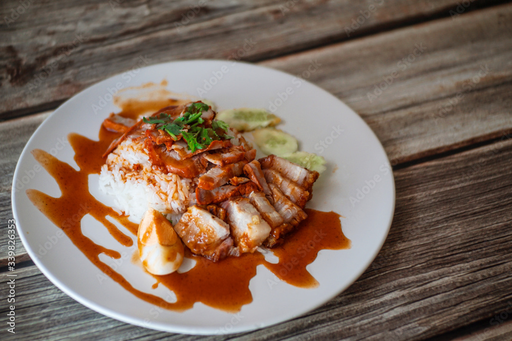 Barbecued red pork and crispy belly pork with sauce and rice. Barbecued red pork and crispy belly pork with sauce and rice.
