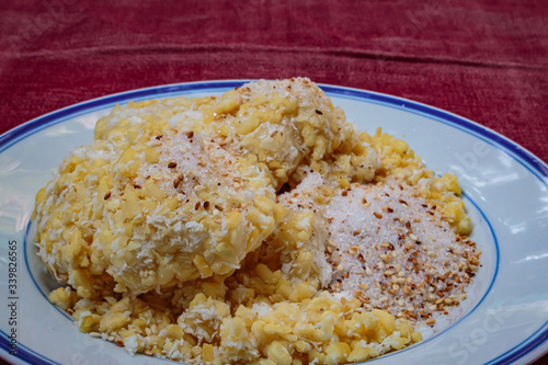 Soft mung bean crepe sprinkled with grated coconut and sugar.