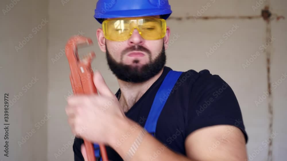 Positive male plumber dancing and having fun Positive male plumber dancing and having fun