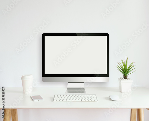 modern computer monitor template mock up on white work desk with blank screen
