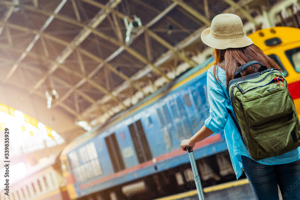 Solo woman backpacker traveler plan safety trip low cost budget summer holiday after coronavirus. Empty tourists on train railway platforms. Use bus train sustainable environmental friendly transport